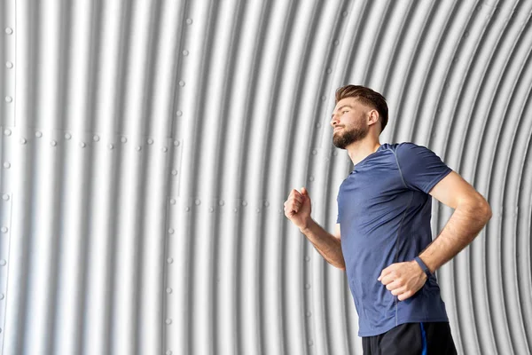 Sporty young man running in tunnel — Stock Photo, Image