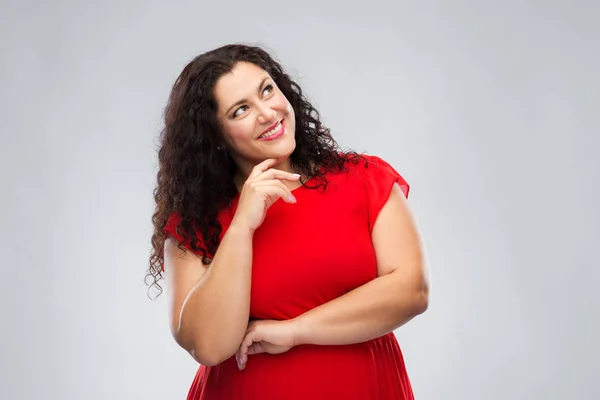 Feliz sonriente mujer en vestido rojo pensando — Foto de Stock