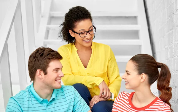 Teenage friends or students hanging out on stairs — Stock Photo, Image