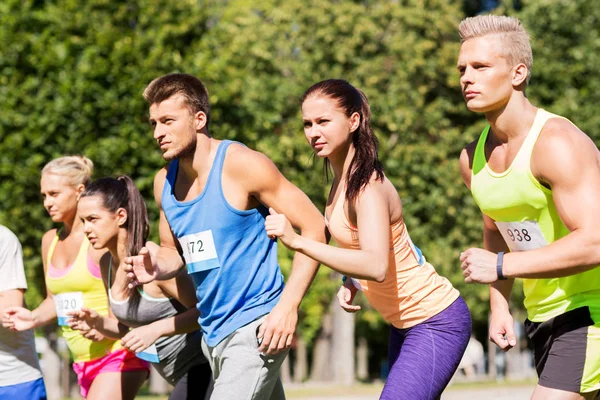 Sportsmen with badge numbers on start of race — Stock Photo, Image