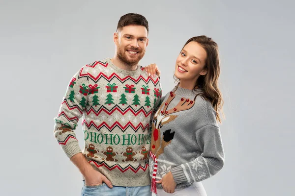 Happy couple at christmas ugly sweater party — Stock Photo, Image