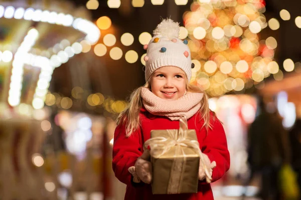 Szczęśliwa dziewczyna z pudełka prezent na Boże Narodzenie rynku — Zdjęcie stockowe