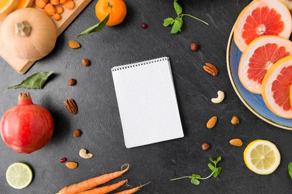 Close up of notebook, fruits and vegetables — Stock Photo, Image