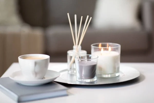 Coffee, candles and aroma reed diffuser on table — Stock Photo, Image