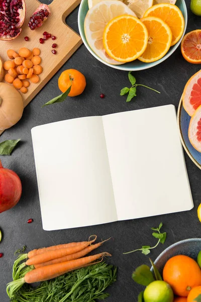 Close up of notebook, fruits and vegetables — Stock Photo, Image