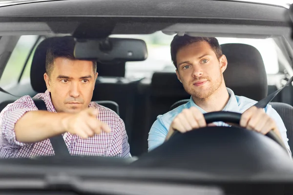 car driving school instructor teaching male driver