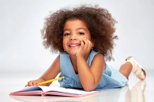 Menina americana africana feliz pouco com sketchbook — Fotografia de Stock