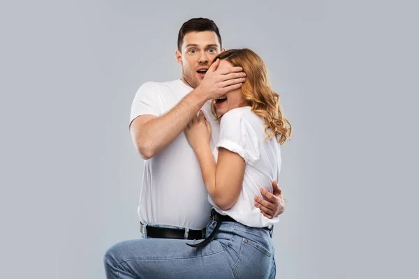 Scared couple in white t-shirts — Stock Photo, Image