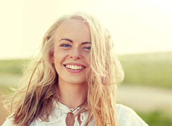 Close up of happy young woman in white outdoors — Stock Photo, Image