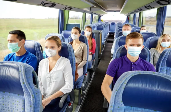 Passengers or tourists wearing masks in travel bus — Stock Photo, Image