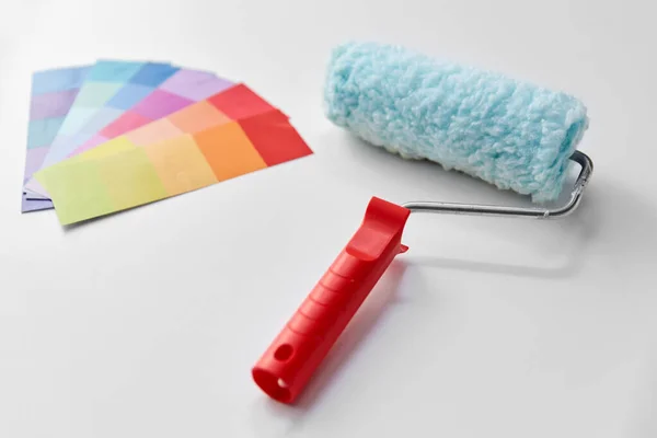 Paint roller and color palette on white background — Stock Photo, Image