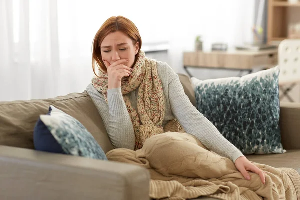 Sick woman in scarf coughing at home — Stock Photo, Image