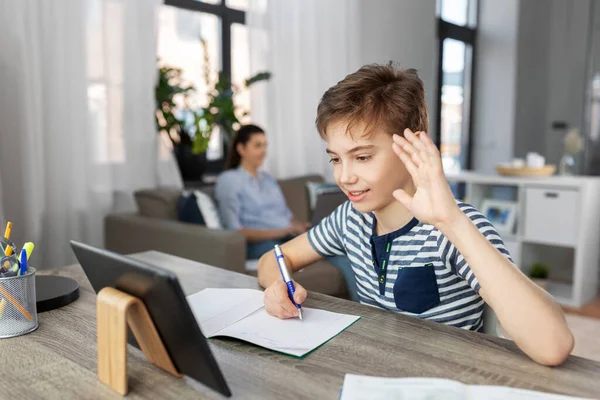 Boy having video call on tablet pc at home — Stock Photo, Image