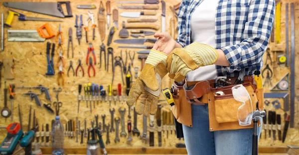 Woman or builder with gloves and working tools — Stock Photo, Image