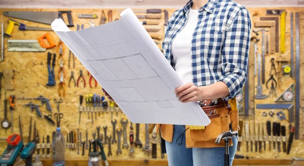 Female builder with blueprint and working tools — Stock Photo, Image