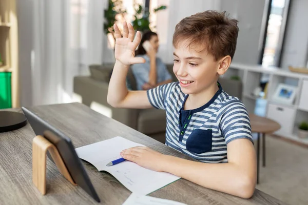 Мальчик с видеозвонком на планшетном компьютере дома — стоковое фото