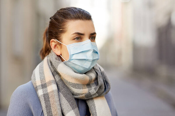 Young woman wearing protective medical mask Stock Photo