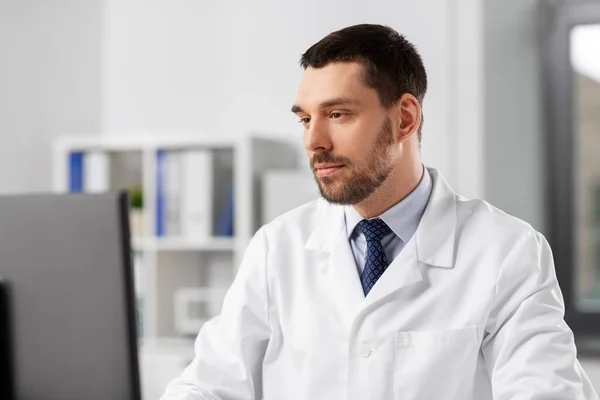 Male doctor with computer working at hospital — Stock Photo, Image