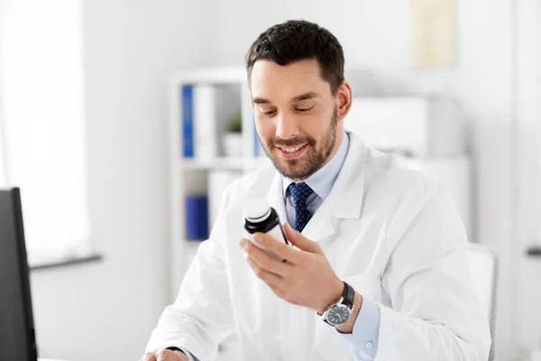 Smiling male doctor with medicine at hospital — Stock Photo, Image
