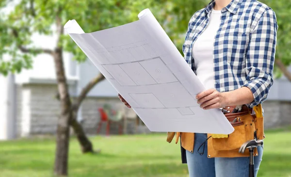 Female builder with blueprint and working tools — Stock Photo, Image