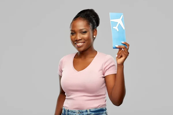Happy african american woman with air ticket — Stock Photo, Image