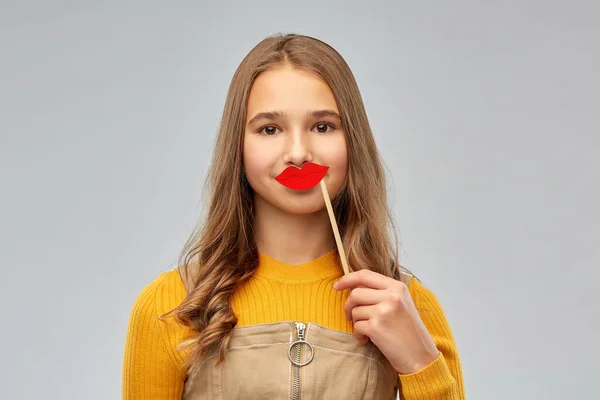 Happy teenage girl with red lips party accessory — ストック写真