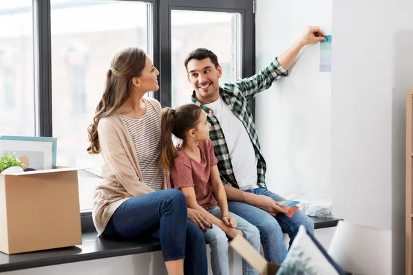 Happy family with color palette moving to new home — Stock Photo, Image
