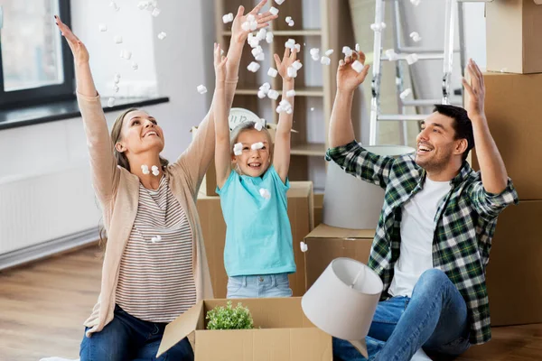 Happy family playing with foam peanuts at new home — Stock Photo, Image