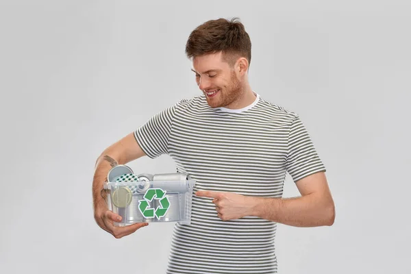 Smiling young man sorting metallic waste — Stock Photo, Image