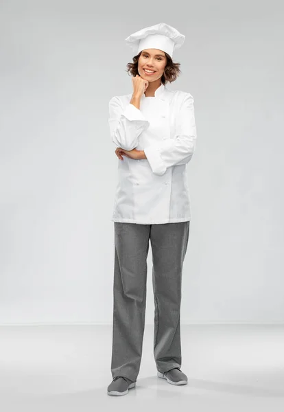 Glimlachende vrouwelijke chef-kok in toque — Stockfoto