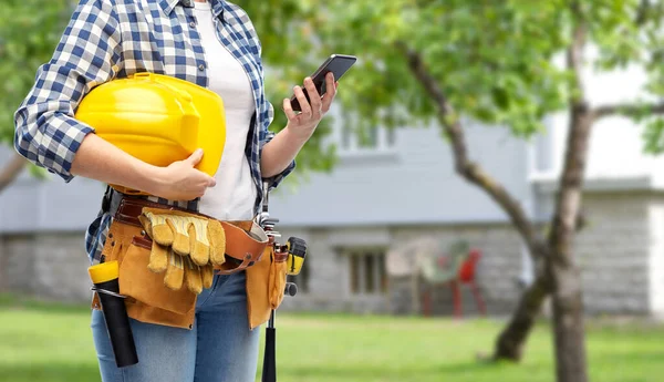 Mulher ou construtor com telefone e ferramentas de trabalho — Fotografia de Stock