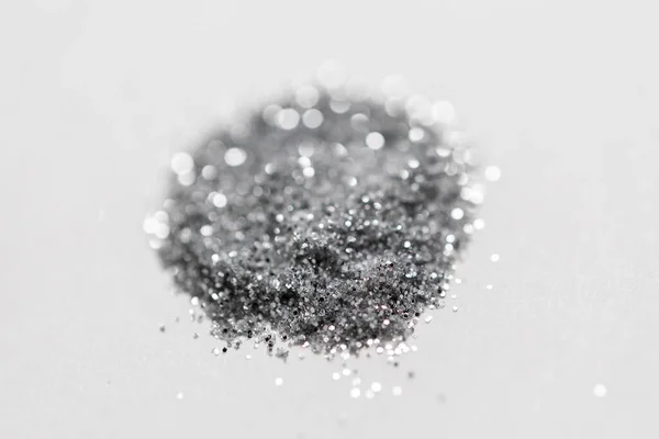 Silver glitters on white background — Stock Photo, Image