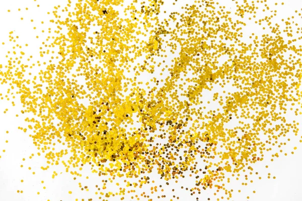 Golden glitters on white background — Stock Photo, Image