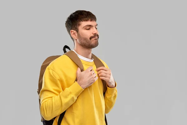 Sad unhappy young man with backpack — Stockfoto
