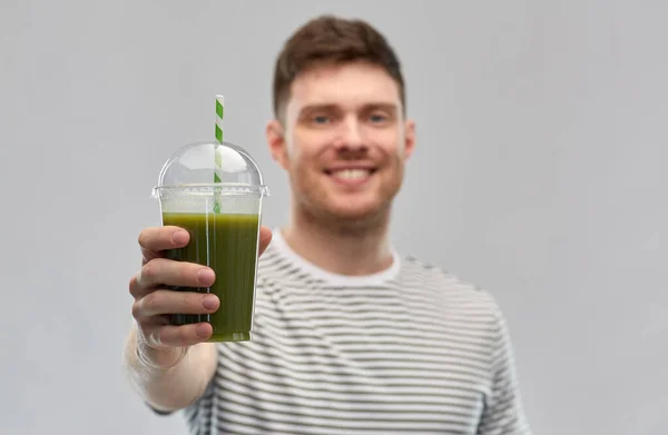 Man dricker grön smoothie från engångskopp — Stockfoto