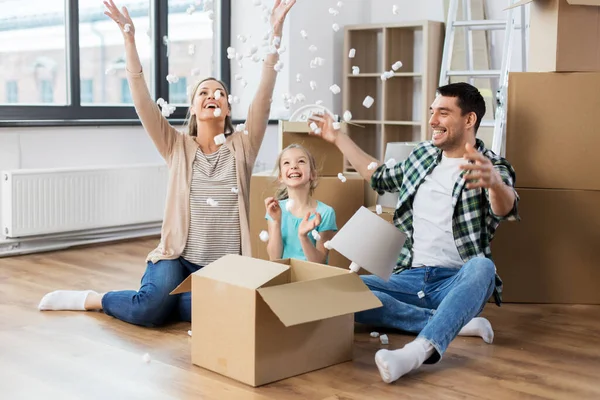 Happy family playing with foam peanuts at new home — Stock Photo, Image