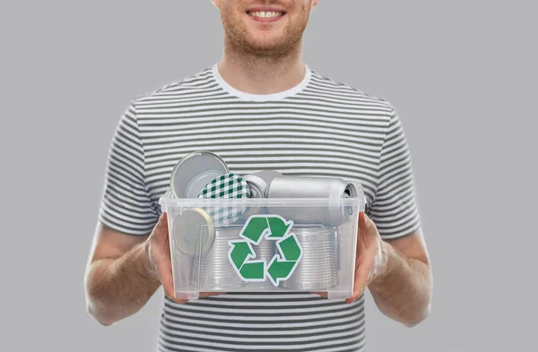 Smiling young man sorting metallic waste — Stock Photo, Image