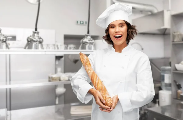 Fransız ekmeği ya da ekmeği olan mutlu kadın şef. — Stok fotoğraf