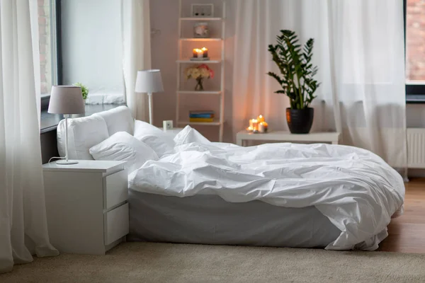 Cozy bedroom with white linen on bed — Stock Photo, Image