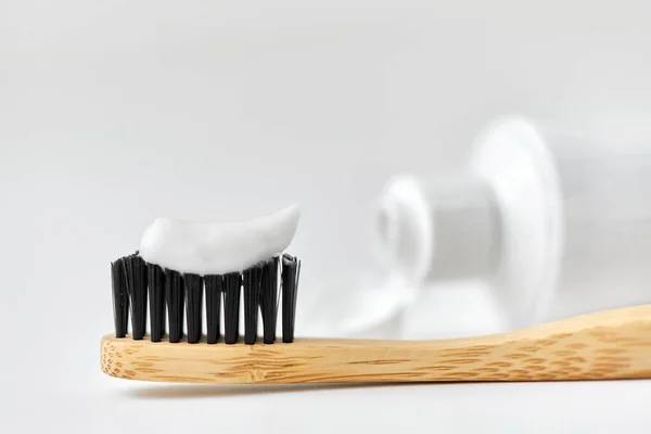 Natural wooden toothbrush with toothpaste on it — Stock Photo, Image