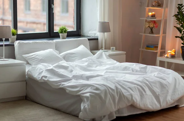 Cozy bedroom with white linen on bed — Stock Photo, Image