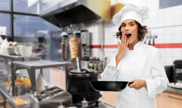 surprised chef with frying pan at kebab shop