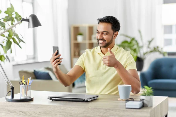 Indian man having video call on smartphone at home — Stock Photo, Image