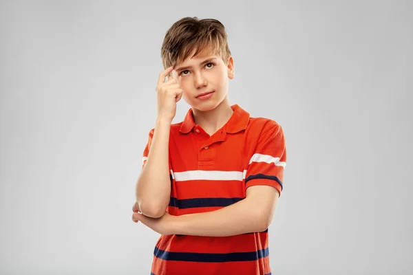 Portrait of thinking boy in red polo t-shirt — Stock Photo, Image