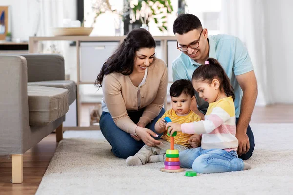 happy family playing with pyramid toy at home