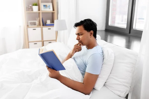 印度男人在床上看书 — 图库照片