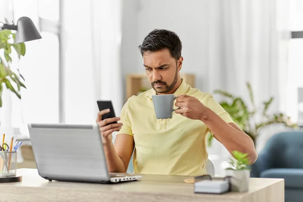 Hombre con teléfono inteligente beber café en casa oficina —  Fotos de Stock
