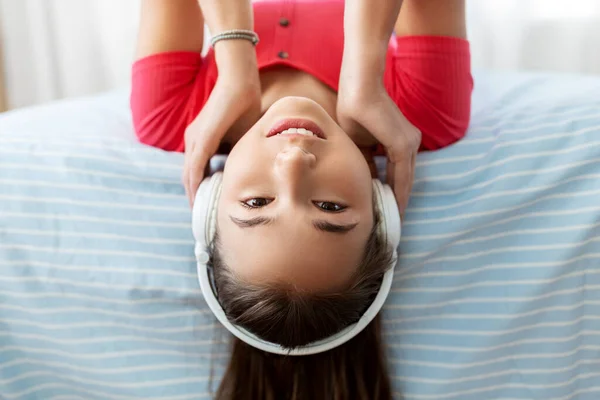 Meisje in hoofdtelefoon luisteren naar muziek thuis — Stockfoto