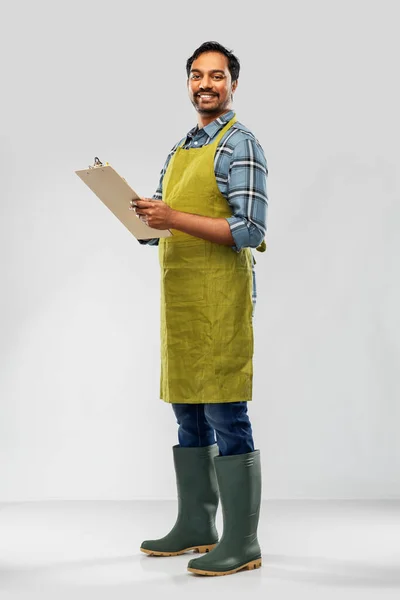Happy indian gardener or farmer with clipboard — Stock Photo, Image