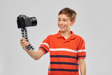 boy video blogger with camera and tripod clipart